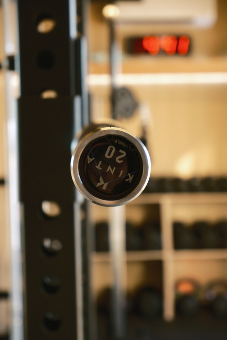 End cap of a barbell, rack and dumbbells beyond