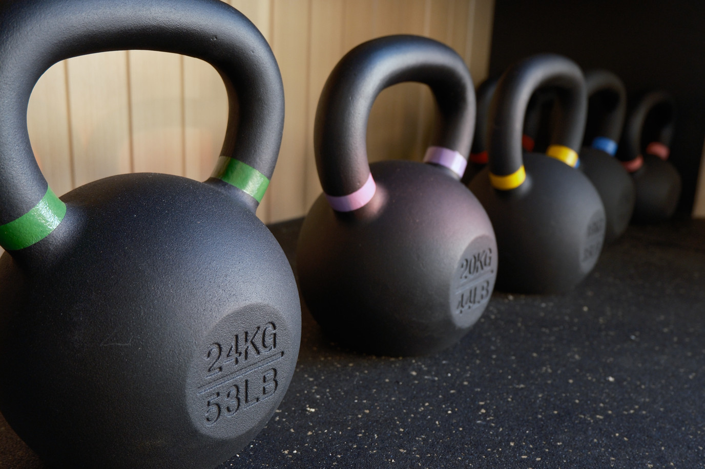 Row of kettlebells on the rubber floor of a crgo unit